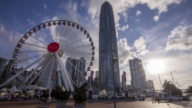 The Hong Kong Observation Wheel, Two International Finance Center (IFC2) and other buildings in Hong Kong, China, on Wednesday, May, 26, 2021. Hong Kong's unemployment rate fell for a second straight month in April as the city slowly emerges from an extended slump fueled by the pandemic and social unrest.