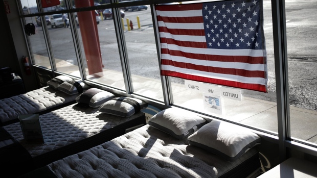 A US flag above mattresses at Charlie Wilson's appliance and TV store in Clarksville, Indiana, US, on Thursday, June 30, 2022. The US Census Bureau is scheduled to release durable goods orders figures on July 6.