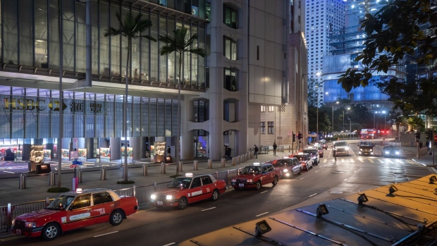 Taxis line up outside the HSBC Holdings Plc headquarters in the Central district in Hong Kong, China, on Friday, Feb. 18, 2022. HSBC is scheduled to release earnings results on Feb. 22.