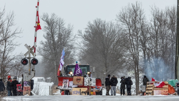 Demonstrators stand near railway tracks during a protest near Belleville, Ontario, Canada, on Thursday, Feb. 13, 2020. Demonstrators have been disrupting railroads and other infrastructure across Canada for more than a week to protest TC Energy Corp.'s planned C$6.6 billion ($5 billion) Coastal GasLink pipeline.