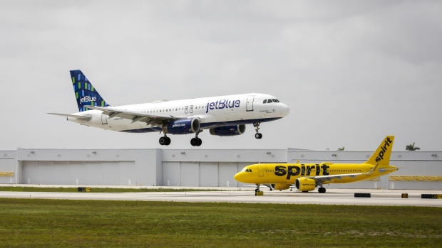 JetBlue and Spirit airplanes at Fort Lauderdale-Hollywood International Airport (FLL) in Fort Lauderdale, Florida, US, on Saturday, May 21, 2022. Spirit Airlines Inc. rebuffed a hostile $3.3 billion takeover offer from JetBlue Airways Corp., setting the stage for a potentially contentious vote by shareholders on whether to back the bid or go with a competing proposal from Frontier Group Holdings Inc.