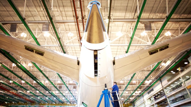 An employee works on the tail of a Boeing Co. Dreamliner 787 plane on the production line at the company's final assembly facility in North Charleston, South Carolina, U.S., on Tuesday, Dec. 6, 2016. On the day President-elect Donald Trump lashed out at Boeing Co. for the cost of replacing Air Force One, mechanics and engineers at the planemaker's South Carolina factory were focused on another challenge: making the first 787-10 Dreamliner. The manufacturer is counting on the newest and longest Dreamliner to help turn its marquee carbon-fiber jet into a cash machine.