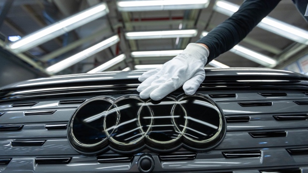 An employee conducts quality control checks on an Audi Q4 e-tron electric vehicle (EV) on the assembly line at the Volkswagen AG (VW) electric automobile plant in Zwickau, Germany, on Tuesday, April 26, 2022. The Zwickau assembly lines are the centerpiece of a plan by VW, the world's biggest automaker, to manufacture as many as 330,000 cars annually.