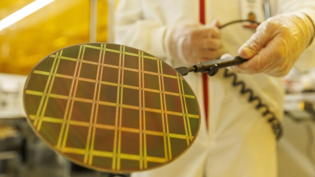 Technicians inspect a semiconductor wafer during testing in the cleanroom at the Tower Semiconductor Ltd. plant in Migdal HaEmek, Israel, on Monday, Feb. 28, 2022. Intel Corp. agreed to acquire Tower Semiconductor for about $5.4 billion, part of Chief Executive Officer Pat Gelsinger’s push into the outsourced chip-manufacturing business.