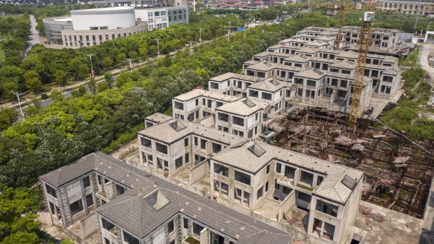 Residential buildings under construction at Tahoe Group Co.'s Cathay Courtyard development in Shanghai, China, on Wednesday, July 27, 2022. The year-long slump in the property market is likely to be a focus for the Politburo, the country's top decision-making body, with the recent spate of people not paying their mortgages threatening to drag sales down even further and damage banks and builders. Photographer: Qilai Shen/Bloomberg