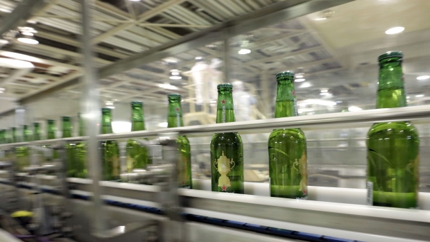 Bottles of Heineken NV brand beer, featuring labels with the Web Ellis Cup logo, move along the production line of a Kirin Brewery Co. factory in Yokohama, Japan, on Tuesday, June 11, 2019. Heineken is the official beer sponsor of the Rugby World Cup. Photographer: Kiyoshi Ota/Bloomberg