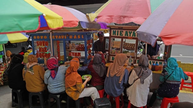 Customers eat at a food stall Tanah Abang market in Jakarta, Indonesia on Saturday, Feb. 26, 2022. Indonesia is scheduled to release its consumer price index (CPI) figures for February on March 1.