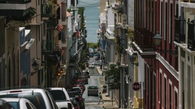 Cars sit parked along a street in the Old City of San Juan, Puerto Rico, on Wednesday, July 8, 2015.