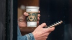 A customer holds a drink inside a Starbucks coffee shop in San Francisco, California, US, on Thursday, July 28, 2022. Starbucks Corp. is expected to release earnings figures August 2.
