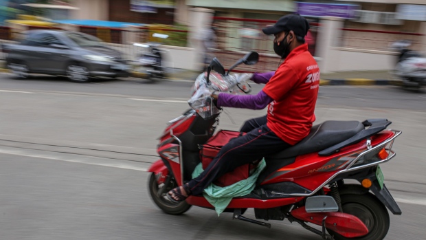 A Zomato Ltd. delivery rider on a motorcycle in Mumbai, India, on Friday, July 16, 2021. Zomato $1.3 billion initial public offering was fully subscribed on the first day of sale, after anchor funds including BlackRock Inc. bid for 35 times more stock than was offered to them. Photographer: Dhiraj Singh/Bloomberg