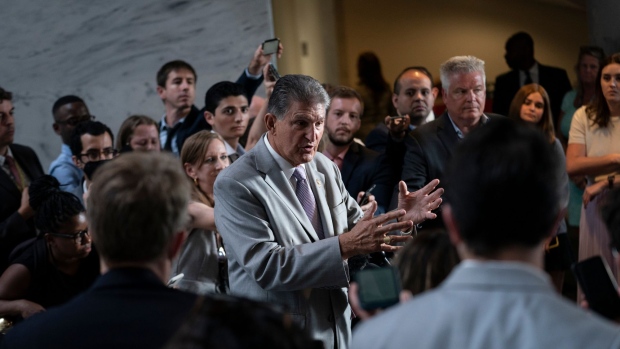 Senator Joe Manchin, a Democrat from West Virginia, center, speaks during a news conference on Capitol Hill in Washington, D.C., US, on Tuesday, Aug. 2, 2022. Republicans are using an obscure rule named for the Senate's longest-serving member to challenge provisions of the Democrats' surprise tax, health and climate deal in the hopes of whittling down the legislation.