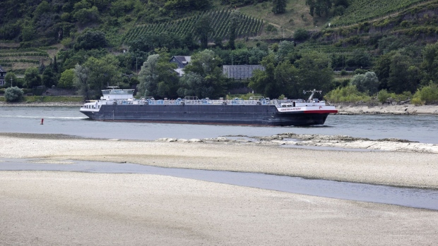 The tanker Constellation sails along a channel past dry banks on the Rhine River near Oberwesel, Germany, on Thursday, July 14, 2022. A heatwave has sent levels on parts of the river, key for shipping everything from coal to oil, to the lowest in at least 15 years on a seasonal basis.
