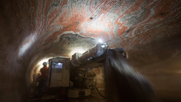 Workers operate a rock drilling machine during excavations for sylvinite mineral ore, used to produce potash fertilizer, in the underground potash mine at the Usolskiy Potash Complex, operated by EuroChem Group AG, at the Verkhnekamskoe deposit in Perm region, Russia. 