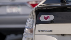 Lyft signage on a vehicle as it exits the ride-sharing pickup at San Francisco International Airport in San Francisco, California, U.S., on Thursday, Feb. 3, 2022. Lyft Inc. is scheduled to release earnings figures on February 8. Photographer: David Paul Morris/Bloomberg