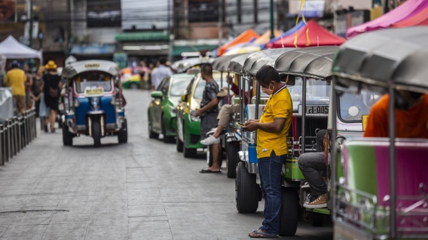 Tuk-tuk drivers wait for customers on Khaosan Road in Bangkok, Thailand, on Saturday, July 2, 2022. Foreign tourist arrivals into Thailand are set to beat official forecasts with the lifting of pandemic-era restrictions, a rare positive for the nation’s Covid-battered economy and currency. Photographer: Andre Malerba/Bloomberg