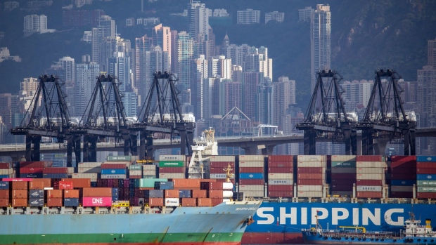 The Seaspan Corp. Emerald container ship, left, sails past the China Ocean Shipping Group Co. (COSCO) England container ship at the Kwai Chung Container Terminal in Hong Kong, China, on Wednesday, May 19, 2021. Hong Kong is scheduled to release trade figures on May 27.
