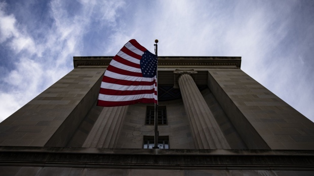 An American flag flies outside the U.S. Department of Justice (DOJ) headquarters in Washington, D.C., U.S., on Saturday, Jan. 2, 2021. A group of 11 Republican senators is pledging to oppose certification of President Donald Trumps election loss, rejecting leadership who warned against attempts to undermine the election or risk splintering the party. Photographer: Samuel Corum/Bloomberg