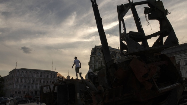 A child climbs on top of a piece of destroyed Russian military equipment displayed at St. Michael's Square in Kyiv, Ukraine, on Monday, June 27, 2022. The North Atlantic Treaty Organization (NATO) announced a plan to boost the size of its high-readiness force to 300,000 as it implements a fundamental shift in its deterrence plans after Russia's invasion of Ukraine.