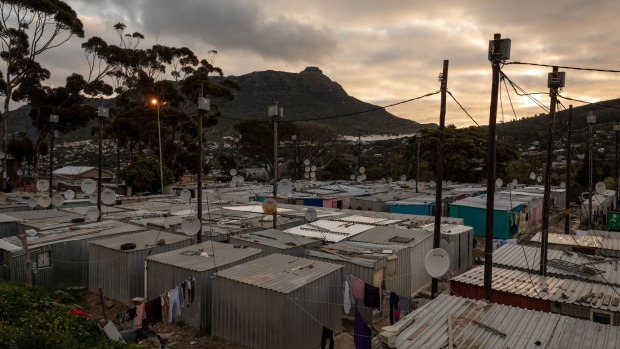 Electrical power lines above informal housing in Cape Town. Photographer: Dwayne Senior/Bloomberg