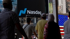 Pedestrians in front of the Nasdaq MarketSite in New York, US, on Wednesday, June 15, 2022. Stocks climbed, Treasury yields tumbled and the dollar pushed lower after Federal Reserve Chair Jerome Powell signaled outsized rate hikes will be rare as officials intensify their battle against rampant inflation. Photographer: Michael Nagle/Bloomberg