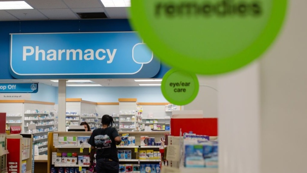 A pharmacist assists a customer at a CVS Health Corp. store in downtown Los Angeles, California, U.S., on Friday, Oct. 27, 2017. The prospect of Amazon.com Inc. entering the healthcare business is beginning to cause far-reaching reverberations for a range of companies, roiling the shares of drugstore chains, drug distributors and pharmacy-benefit managers, and potentially precipitating one of the biggest corporate merger deals this year.