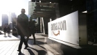 Pedestrians walks past Amazon.com Inc. headquarters in the financial district of Toronto, Ontario, Canada, on Friday, Feb. 21, 2020. Stephanie Foden/Bloomberg