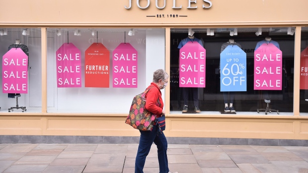WORCESTER-ENGLAND - MARCH 27: A lady wearing a mask walks past a closed Joules shop in Worcester Town Center on March 27, 2021 in Worcester, England . (Photo by Nathan Stirk/Getty Images)