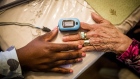 Nikesha McPherson, a nurse practitioner for Clover Health, uses a pulse oximeter on Margarita Varon at her home in Plainfield, New Jersey, U.S., on Wednesday, Oct. 26, 2016. Venture investors have put in almost $300 million since last year in Clover's data-driven approach to health care. Photographer: John Taggart/Bloomberg