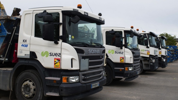 Garbage trucks in a yard at a Suez SA waste recycling site in the Gennevilliers district in Paris, France, on Tuesday, May 11, 2021. Veolia Environnement SA, the world’s largest waste and water utility, shook the industry last summer when it launched a takeover offer for Suez, triggering a seven-month feud in courts and through media.
