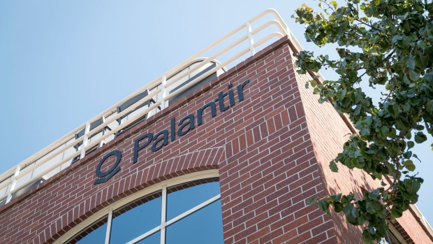 Palantir Technologies Inc. signage is displayed outside the company's headquarters in Palo Alto, California, U.S., on Tuesday, Sept. 29, 2020. Palantir, the Peter Thiel-backed data-mining startup, could have a market value of more than $20 billion when it starts trading, analysts have predicted. Photographer: David Paul Morris/Bloomberg
