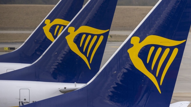 The tail fins of passenger aircraft, operated by Ryanair Holdings Plc, on the tarmac at London Stansted Airport, operated by Manchester Airport Plc, in Stansted, U.K., on Monday, Jan. 10, 2022. The U.K. will no longer require vaccinated travelers to take a Covid-19 test before boarding a flight to the country, after airlines hard-hit by the omicron variant lobbied for the rules to be eased. Photographer: Jason Alden/Bloomberg