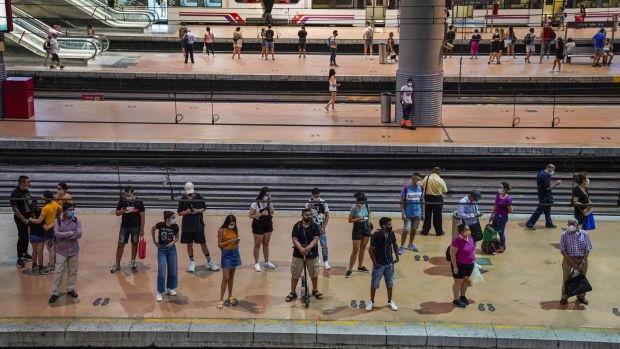 Passengers wait for a train on the regional services platform at Atocha rail station in Madrid, Spain, on Wednesday, Aug. 5, 2020. Lockdowns have witnessed a surge in eco-friendly mobility policies like bike lanes, scooter rentals and pedestrianized plazas, which may well prove more than fleeting trends.
