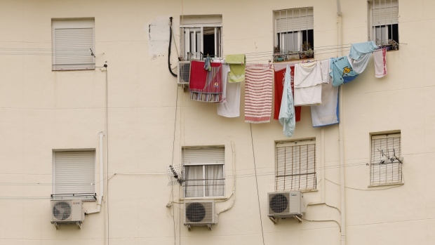 Air conditioning units beneath a washing line on the facade of a residential building during a heat wave in Seville, Spain, on Wednesday, June 15. 2022. The scorching weather provides another example of the impact climate change will have as countries’ reliance on burning fossil fuels makes the planet hotter.