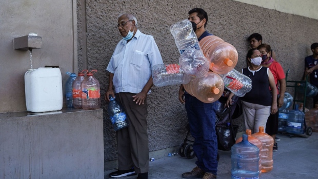 Residents wait in line to fill containers with clean water during a shortage in Monterrey, Nuevo Leon state, Mexico, on Monday, June 20, 2022. A climate-fueled water crisis in the country’s industrial capital leaves residents thirsty and people illegally tapping pipes.
