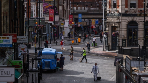 Pedestrians cross a junction in Croydon, UK, on Monday, July 25, 2022. UK inflation running at the fastest pace since the early 80s. Photographer: Hollie Adams/Bloomberg