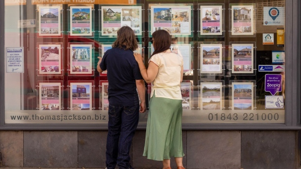 Pedestrians look at properties listings in an estate agents window in Margate, UK, on Friday, June 17, 2022. Experts say office workers being set free offers a rare opportunity to kickstart sluggish economies.