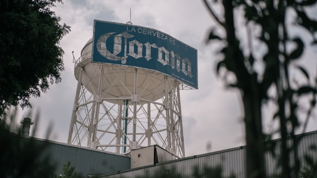 Signage for Grupo Modelo Corona brand beer stands on display outside the company's brewery in Mexico City, Mexico, on Monday, June 1, 2020. Despite Covid-19 cases rising, Mayor Claudia Sheinbaum said Mexico City will begin a gradual reopening June 1, when some sectors of the economy allowed to resume operations.