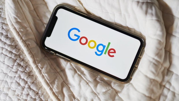 The Google Inc. logo is displayed on an Apple Inc. iPhone in this arranged photograph taken in Little Falls, New Jersey, U.S., on Saturday, July 20, 2019. Alphabet Inc. is scheduled to release earnings figures on July 25. Photographer: Gabby Jones/Bloomberg