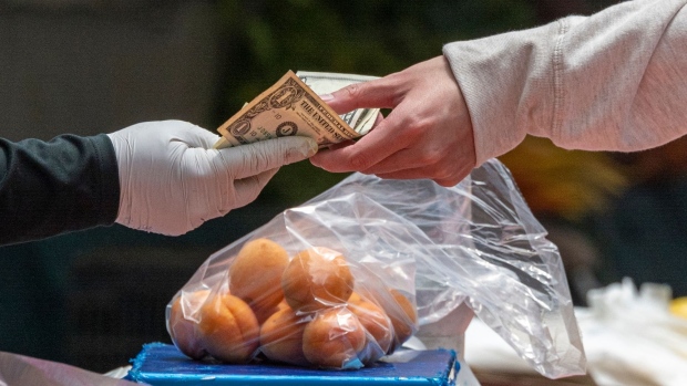 A shopper buys fruit at a farmers market in San Francisco, California, US, on Thursday, June 2, 2022. The Biden administration announced $2.1 billion in new funding Wednesday to bolster food supply chains, including efforts to support smaller processors and help farmers shift to organic production. Photographer: David Paul Morris/Bloomberg