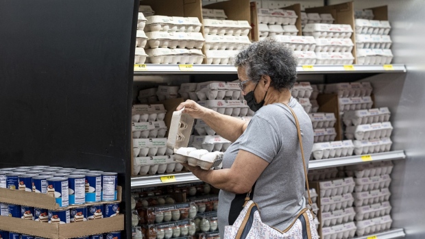 A shopper checks a carton of eggs inside a grocery store in San Francisco, California, U.S.