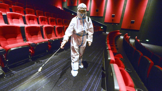 A staff disinfects a cinema in Urumqi, Xinjiang on Aug. 9. Photographer: Liu Xin/China News Service/Getty Images
