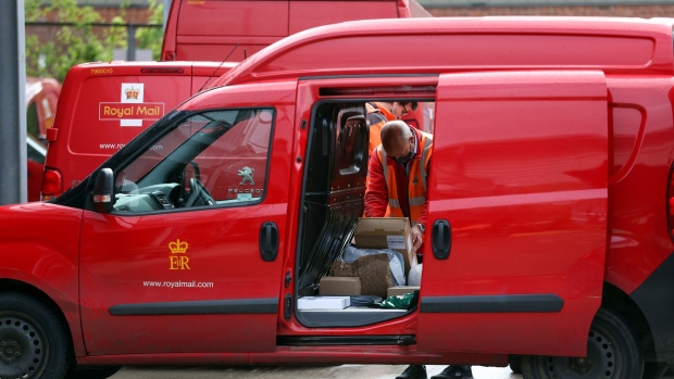 An employee places parcels for delivery into a van at the Royal Mail Plc sorting office in Chelmsford, U.K., on Thursday, May 13, 2021. Royal Mail are due to report earnings on Thursday, May 20.