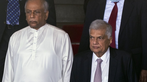Ranil Wickremesinghe, Sri Lanka's president, and Dinesh Gunawardena, Sri Lanka's prime minister, leave the ceremonial opening session of the Parliament in Colombo, Sri Lanka, on Wednesday, Aug. 3, 2022. Sri Lanka’s newly- elected President Ranil Wickremesinghe has invited lawmakers to form an all-party government to overcome the current economic crisis. Photographer: Buddhika Weerasinghe/Bloomberg