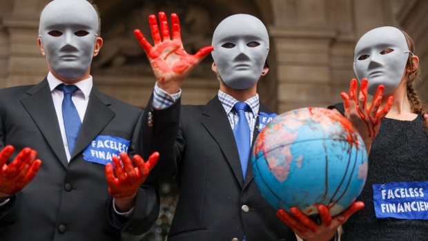 Climate activists from Extinction Rebellion gather during their "Blood Money March" protest as part of their Impossible Rebellion campaign, near the Bank of England in London, U.K., on Friday, Aug. 27, 2021. The group which describes itself as "a global movement that uses non-violent civil disobedience in an attempt to halt mass extinction and minimize the risk of societal collapse" has planned two weeks of protests until Sept. 4.