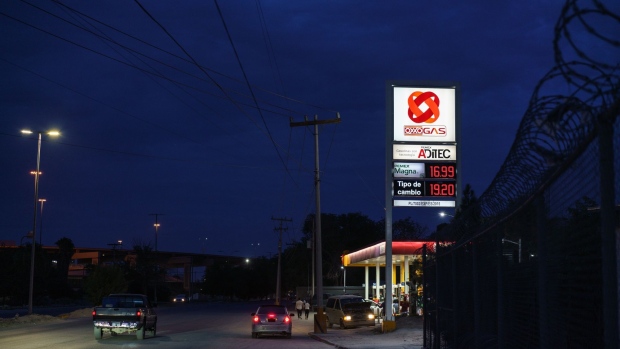 An Oxxo gas station is pictured at night in Ciudad Juárez, Chihuahua State, Mexico on Thursday, July 21, 2022. As high gas prices in the United States have persisted, lower Mexican gas prices attract cross border customers due to a subsidy given by the Mexican government. Photographer: Paul Ratje/Bloomberg