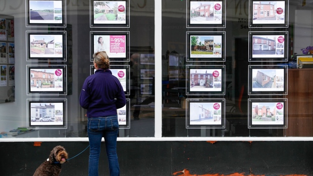 A pedestrian looks at residential sales displayed in the window of an estate agent in Loughborough, U.K., on Monday, July 5, 2021. Global valuations in the property markets are soaring at the fastest pace since 2006, according to Knight Frank, with annual price increases in double digits.