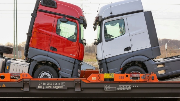 New haulage trucks loaded onto a train at the customer delivery center outside the Daimler AG truck factory in Woerth, Germany, on Thursday, Feb. 4, 2021. Daimler is moving ahead with plans for an initial public offering of its sprawling heavy-truck unit in what could be one of Germany’s largest share sales ever.