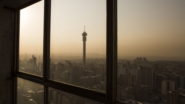 The Hillbrow Tower, operated by Telkom SA SOC Ltd., center left, stands on the city skyline at dusk in Johannesburg, South Africa, on Thursday, Oct. 10, 2019. South Africa's economy remains stuck in its longest downward cycle since 1945, adding to pressure on the government to implement reforms to lift business confidence and boost growth. Photographer: Guillem Sartorio/Bloomberg