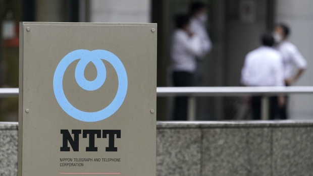 Signage is displayed outside the Nippon Telegraph and Telephone Corp. (NTT) headquarters in Tokyo, Japan, on Tuesday, Sept. 29, 2020. NTT's plan to make its wireless unit wholly owned increases the chances it will comply with calls from Japan’s new premier for lower mobile fees, forcing rivals to follow suit, according to some analysts. Photographer: Toru Hanai/Bloomberg