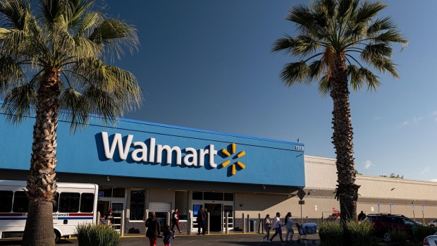 Shoppers walk outside a Walmart store in San Leandro, California, U.S., on Thursday, May 13, 2021. Walmart Inc. is expected to release earnings figures on May 18.